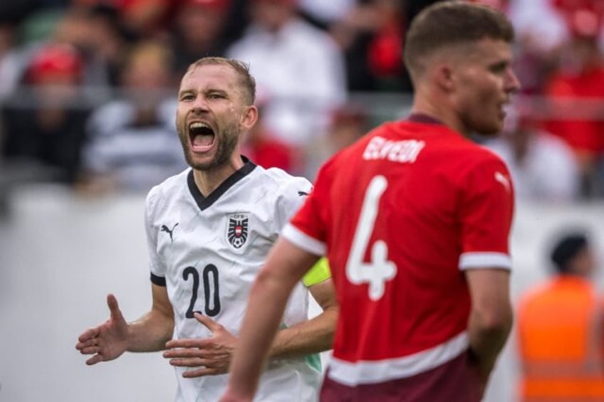 Austria's midfielder Konrad Laimer (L) and Switzerland defender Nico Elvedi featured at th