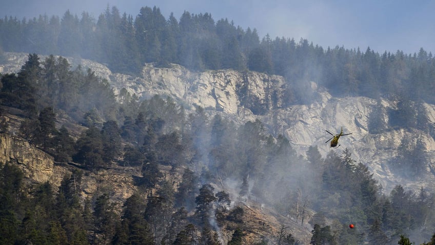 switzerland orders hang gliders to avoid mountainside as firefighters battle forest fire