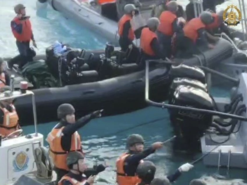 In this handout photo provided by Armed Forces of the Philippines, Chinese Coast Guard hol