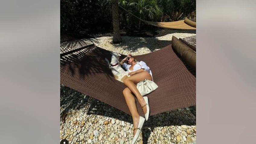 Sydney Sweeney in a hammock with her dog