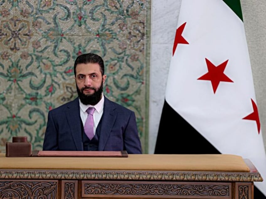 DAMASCUS, SYRIA - MARCH 13: Syrian President Ahmed al-Sharaa signs a declaration outlining