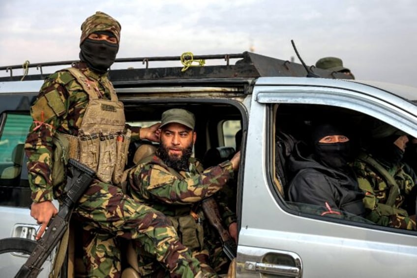 Fighters loyal to the interim Syrian government, in the Zahra district of Homs