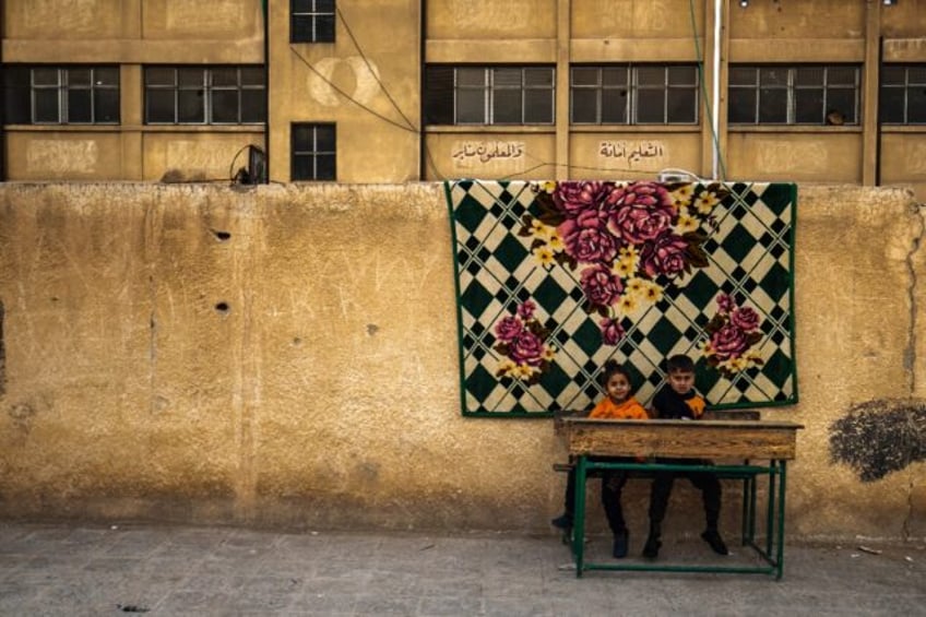 Children who fled ongoing battles between Turkish-backed groups and Syrian Kurdish forces