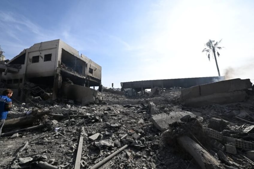 A man stands amid the rubble of the Barzeh defence research centre north of Damascus