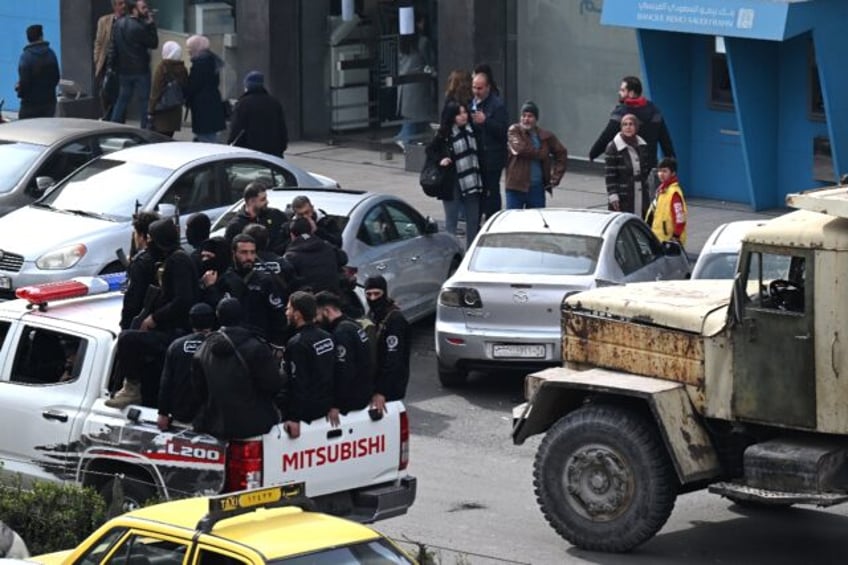 Security forces with Syria's new government patrol in Damascus on February 3, 2025