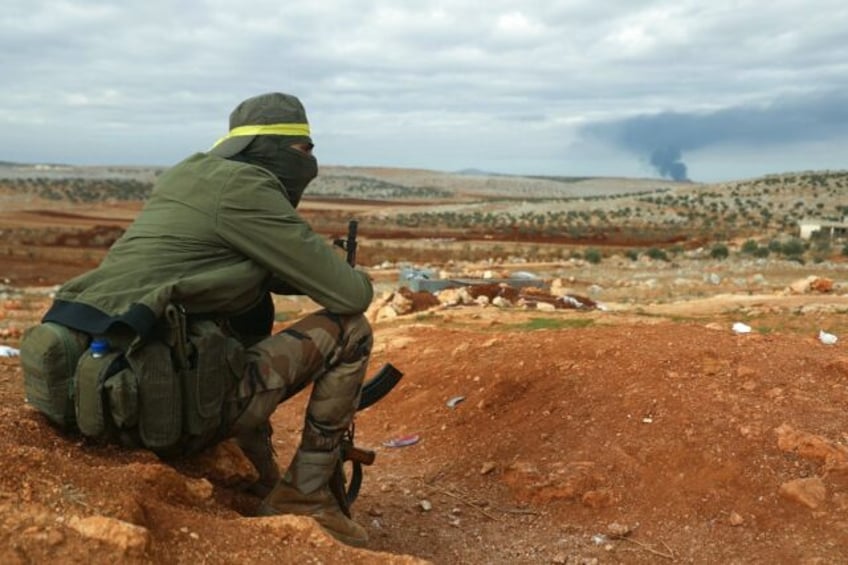 A fighter from Hayat Tahrir al-Sham (HTS) mans a position in the eastern outskirts of Atar