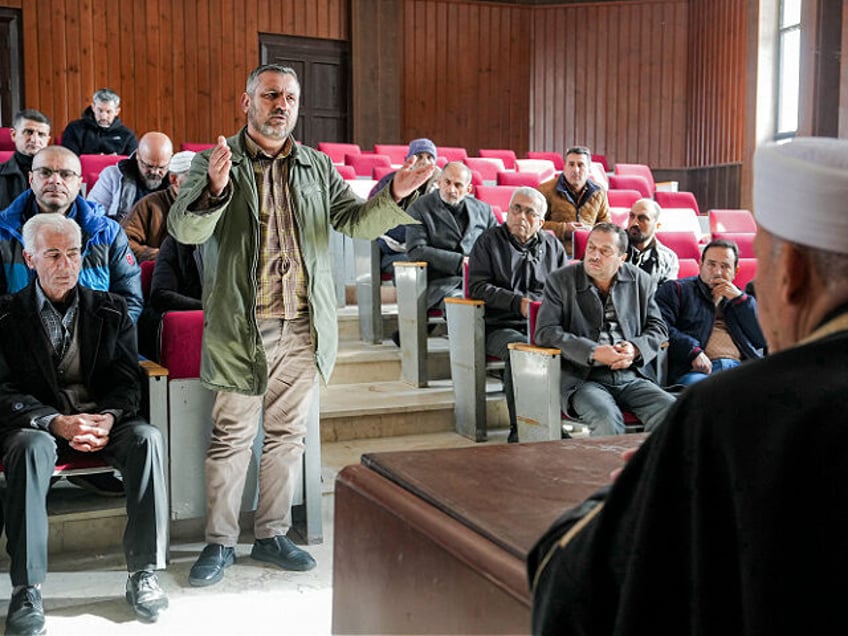 Clerics and members of Syria's Alawite minority gather for a meeting in Qardaha, the ances