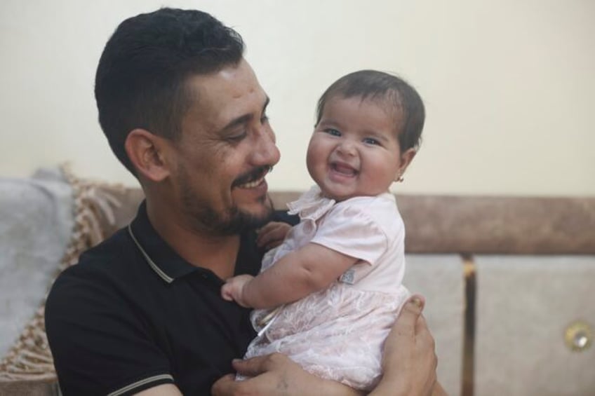 syrian baby born under earthquake rubble turns 6 months happily surrounded by her adopted family