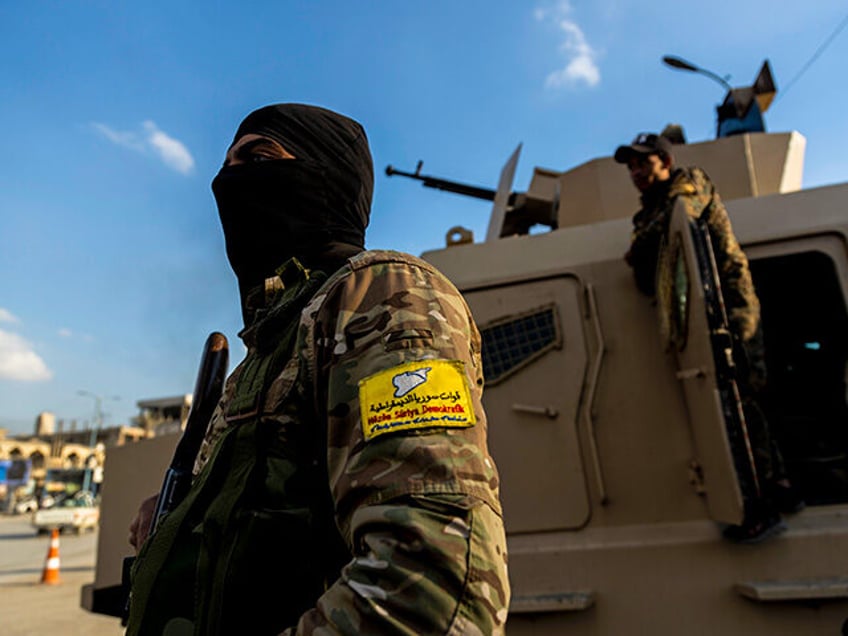 U.S.-backed Syrian Democratic Forces (SDF) fighters stand guard in Raqqa, Syria, on Feb. 7