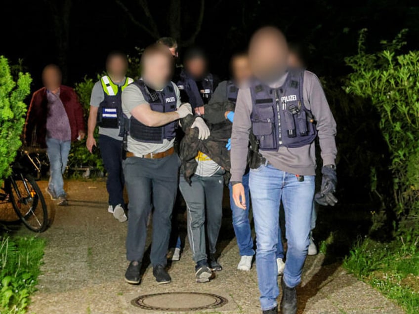 dpatop - 19 May 2025, Heiligenhaus: Police officers take away the suspect of the attack in