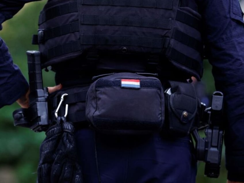 Detail of a Dutch police officer's uniform and equipment as he patrols outside the Jewish school Rosh Pina in Amsterdam on October 13, 2023. The three Amsterdam-based Jewish schools Rosh Pina, Maimonides and Cheider will remain closed until October 16, 2023, after Palestinian Islamist group Hamas called for Muslims to …