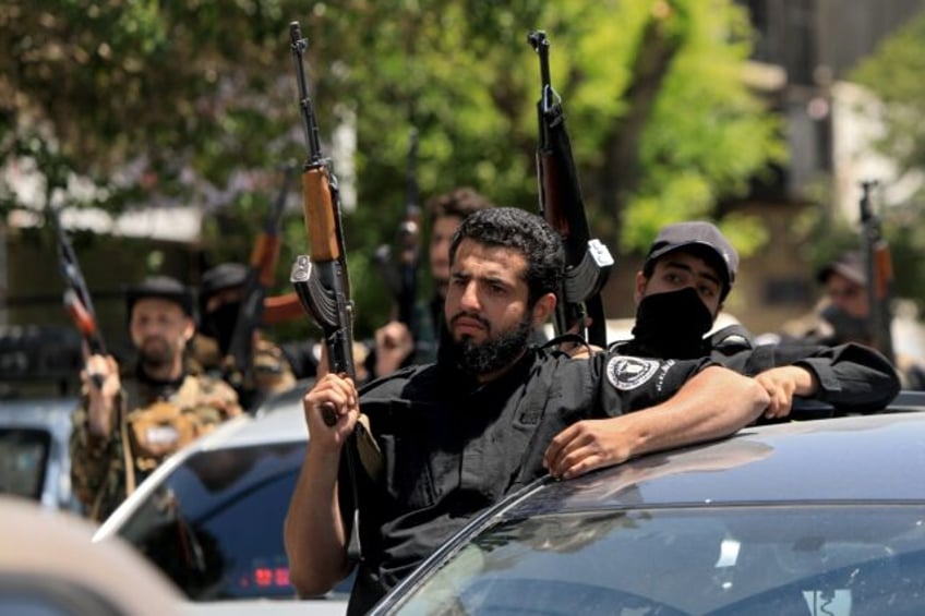 Members of Syria's security forces stand guard in Damascus following overnight sectarian c
