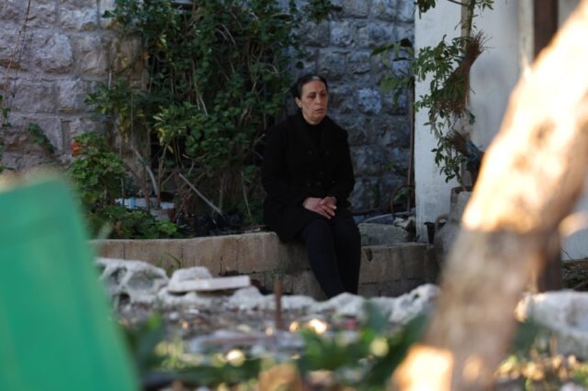 Nisrine Ezzedine sits in her garden where her husband, son and nephew are buried