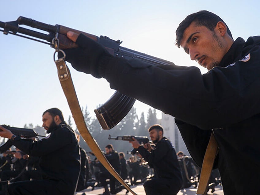 Recruits for the new government's police force hold their weapons in a firing position dur