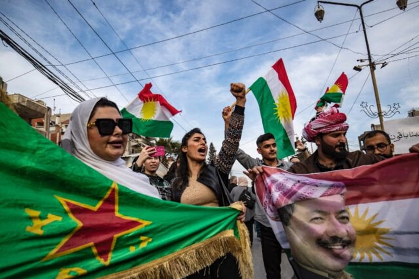 Demonstrators in mainly Kurdish northeastern Syria wave Kurdish flags as they protest agai