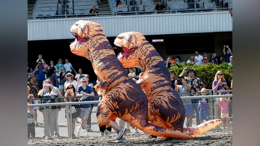 Two T-Rex racers compete as spectators look on at the T-Rex World Championships