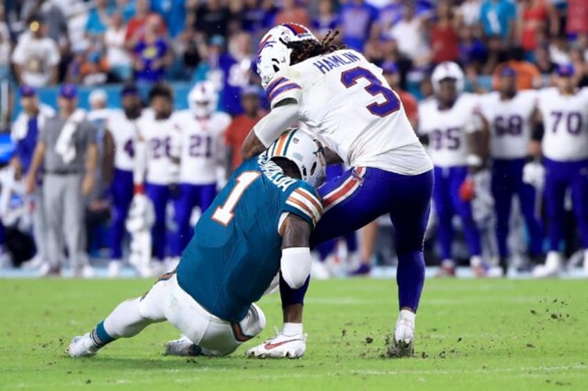 Tua Tagovailoa of the Miami Dolphins collides with Damar Hamlin of the Buffalo Bills durin