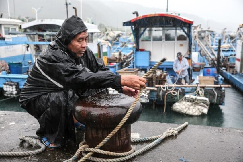 A fisherman secures a boat as Typhoon Kong-rey approaches Taiwan's Yilan County on Wednesd