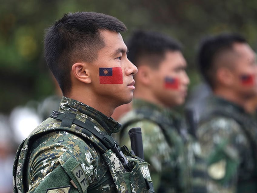 Taiwanese soldiers have Taiwan national flags painted on their faces during National Day celebrations held in front of the Presidential Building in Taipei, Taiwan, Tuesday, Oct. 10, 2023. (AP Photo/Chiang Ying-ying)