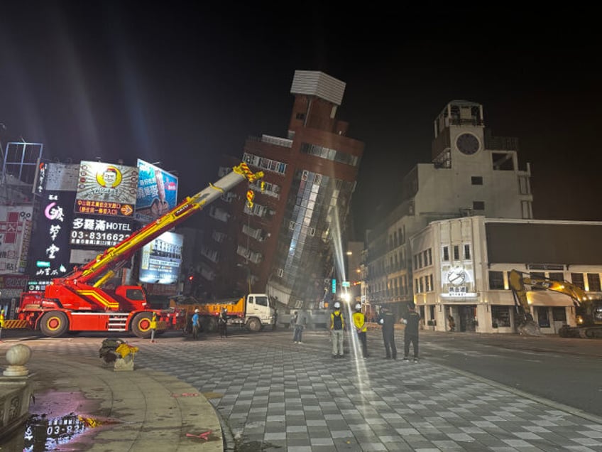 HUALIEN, CHINA - APRIL 03: Rescuers search for individuals trapped in a severely tilted bu