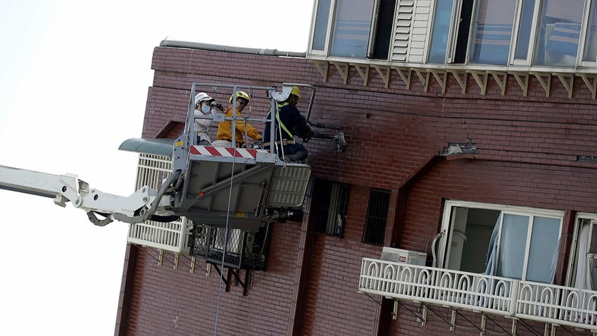 Engineers take samples from building struck by earthquake in Taiwan