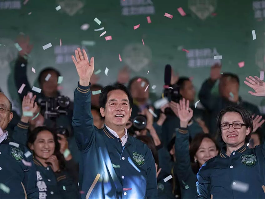 Taiwanese Vice President Lai Ching-te, also known as William Lai, left, celebrates his victory with running mate Bi-khim Hsiao in Taipei, Taiwan, Saturday, Jan. 13, 2024. The Ruling-party candidate has emerged victorious in Taiwan's presidential election and his opponents have conceded. (AP Photo/Louise Delmotte)