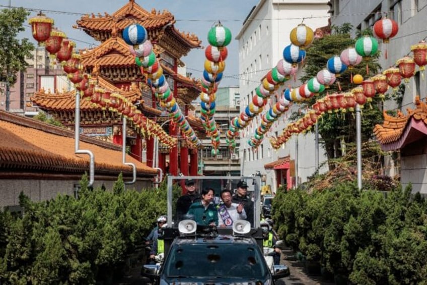 Taiwan Vice President and presidential candidate of the ruling Democratic Progressive Party (DPP) Lai Ching-te (L) campaigns in Kaohsiung on Monday