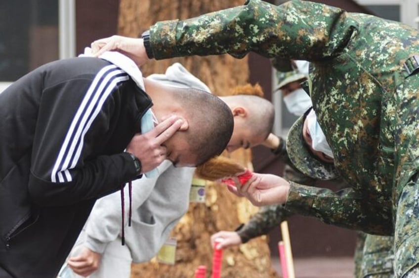 The new recruits arriving in Taiwan's western city of Taichung are the first batch taking part in the island's one-year mandatory military service