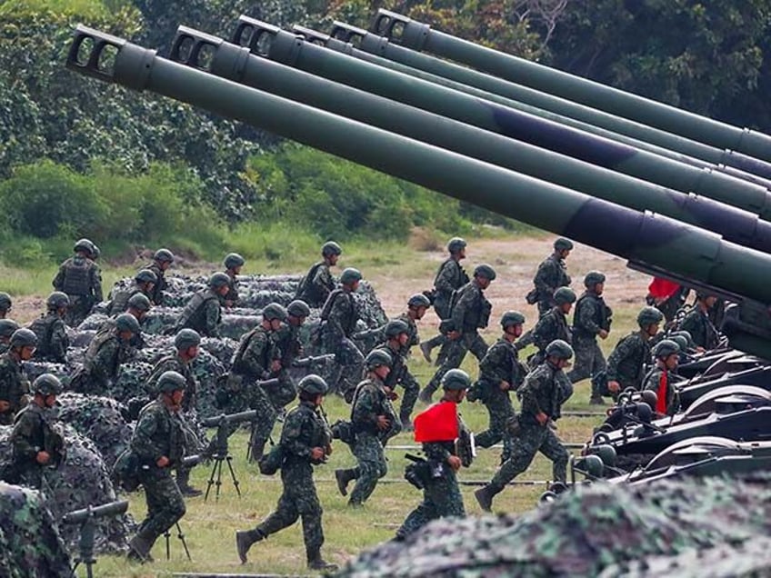 Taiwanese soldiers take part in a live-ammunition artillery training conducted by the Taiw