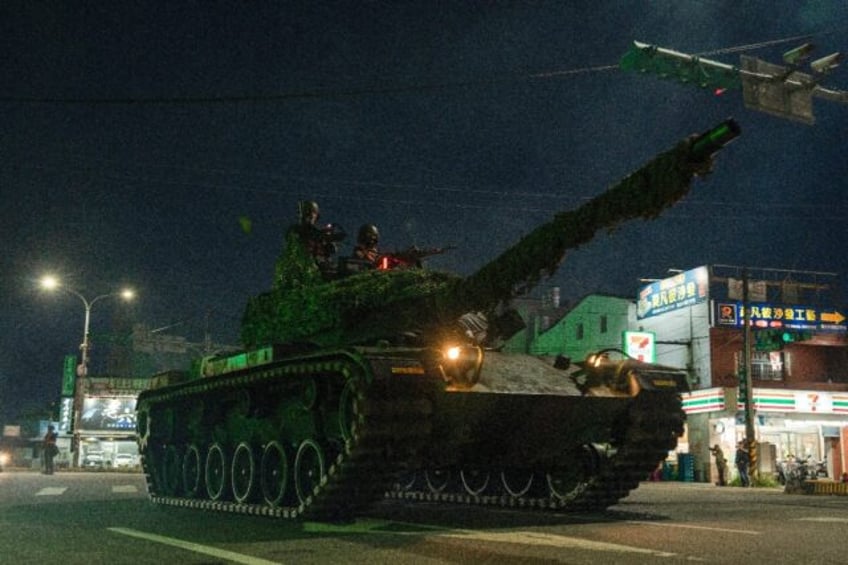 A tank drives through the streets of Taiwan's Taoyuan on the first day of annual, week-lon