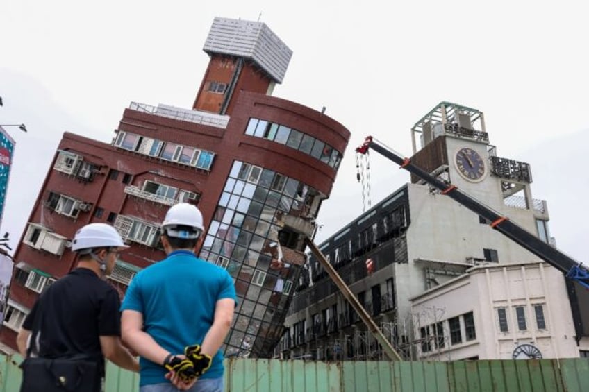 Contruction equipment is used to demolish a building in Hualien left tilting following Wed