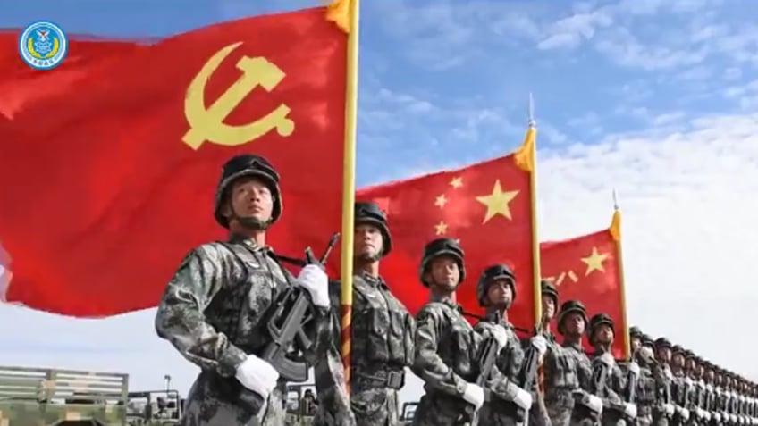 Chinese soldiers with Chinese flag in background