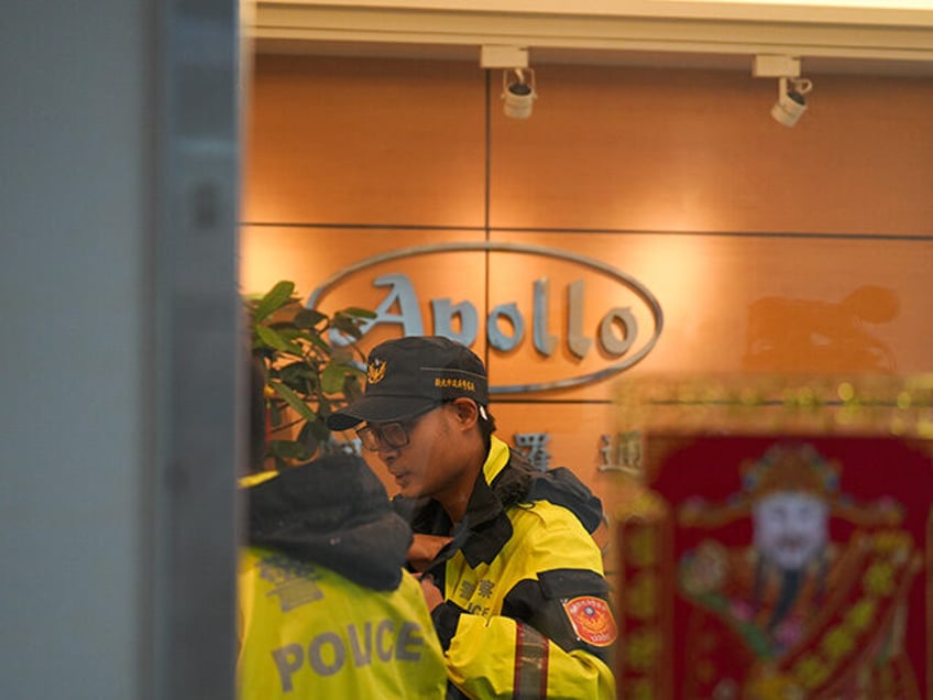 Police officers are seen at Taiwanese company Gold Apollo office in New Taipei, Taiwan, Se