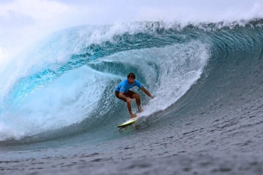 French-Tahitian surfer Mateia Hiquily rides a wave in Teahupo'o, Tahiti, where the Olympic