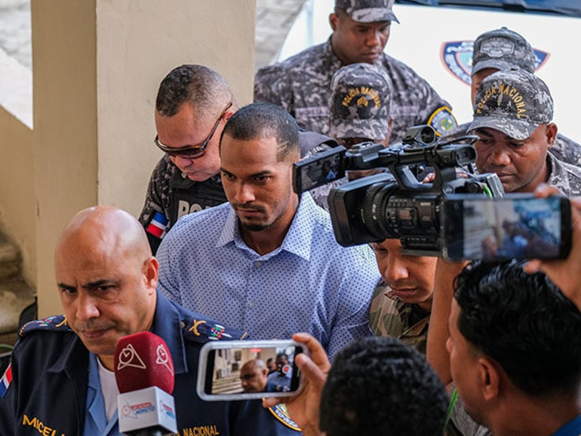 Tampa Bay Rays shortstop Wander Franco, center, is escorted by police to court in Puerto P