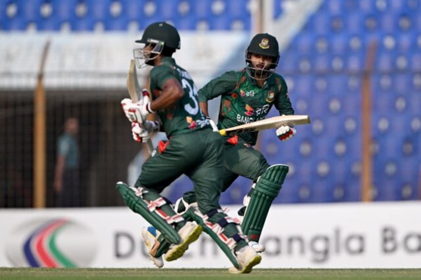 Bangladesh's Towhid Hridoy (R) and Tanzid Hasan run between the wickets during the third a