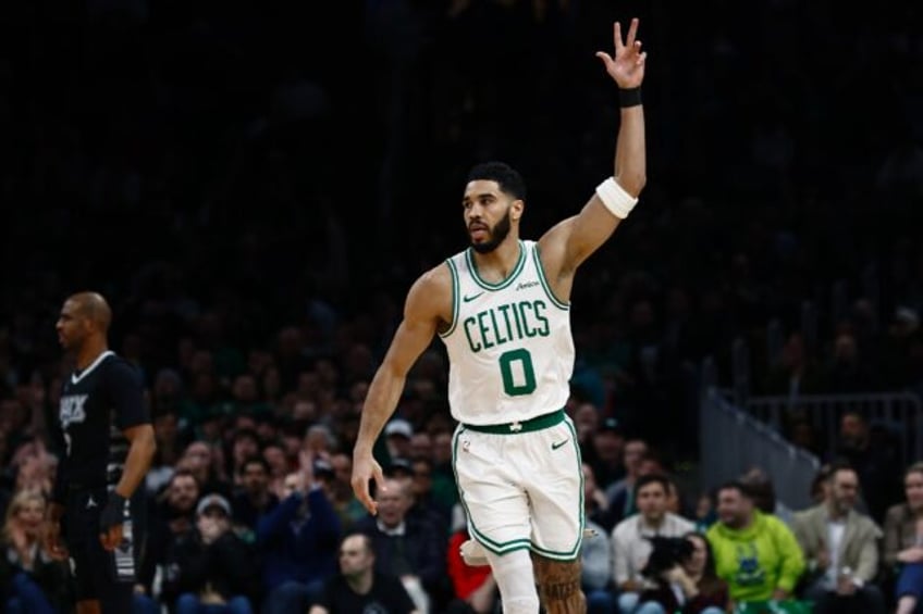 Boston's Jayson Tatum celebrates after making a three-point basket in the Celtics' NBA vic