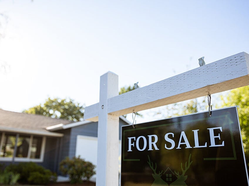 Image of a real estate for sale sign posted in front of a residential home in Portland Ore