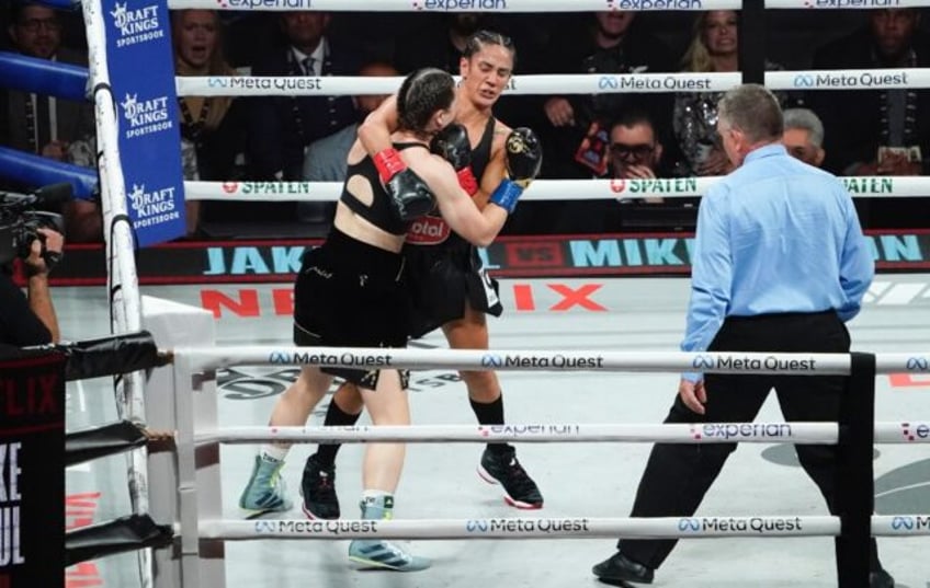 Puerto Rico's Amanda Serrano (right) and Ireland's Katie Taylor grapple during their bruis