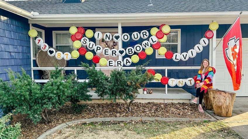 Sarah Krivena poses next to her Swiftie-inspired Super Bowl decorations in Kansas City, Kansas