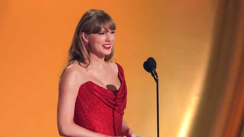 Taylor Swift presents an award at the Grammys