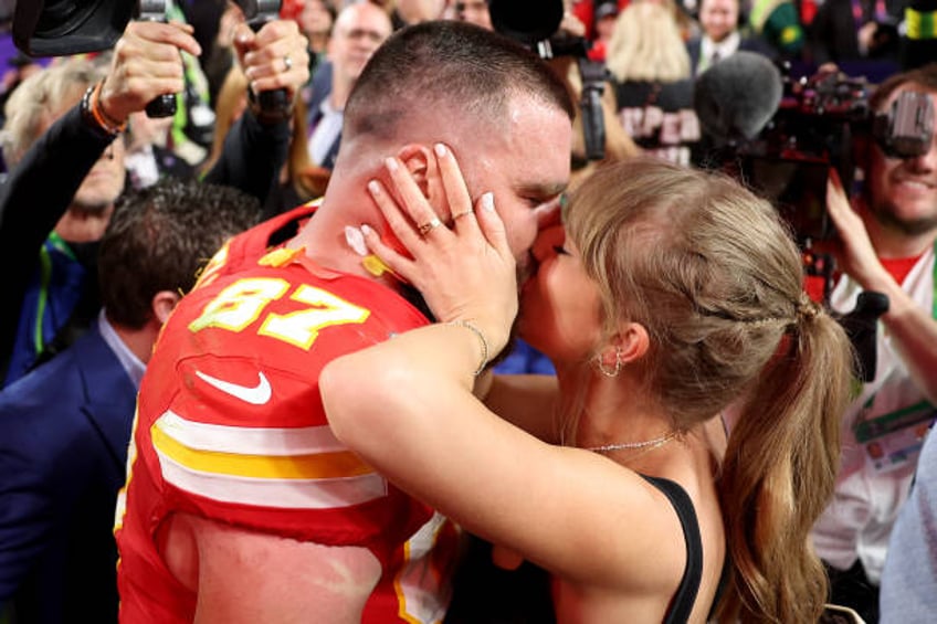 Travis Kelce of the Kansas City Chiefs kisses Taylor Swift after defeating the San Francisco 49ers 2 during Super Bowl LVIII at Allegiant Stadium on...