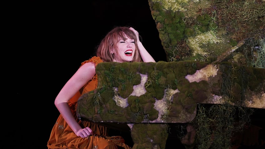 Taylor Swift smiles on stage at Eras Tour