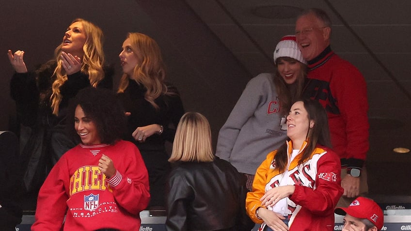 Taylor Swift hugging her dad Scott Swift at a Kansas City Chiefs game