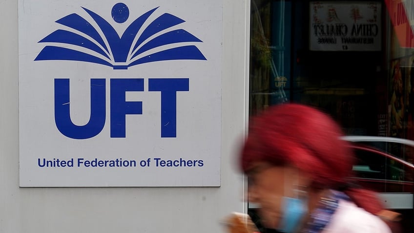 A pedestrian walks past the United Federation of Teachers (UFT) building