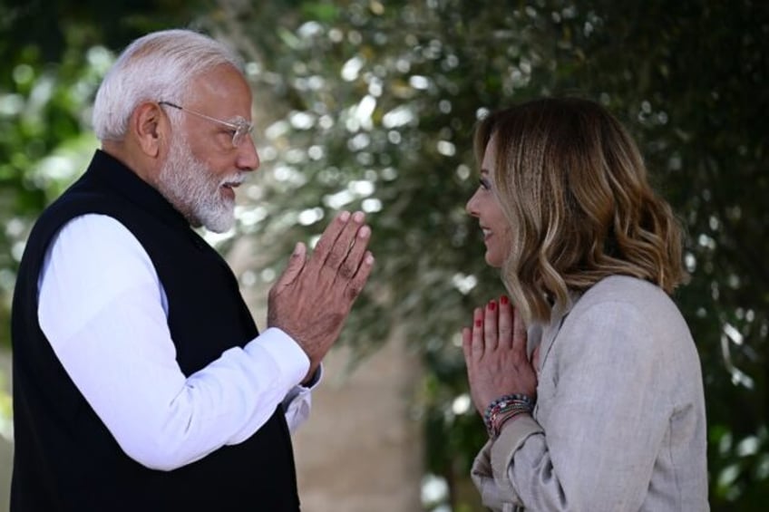 Indian Prime Minister Narendra Modi is welcomed by Italy's Prime Minister Giorgia Meloni o