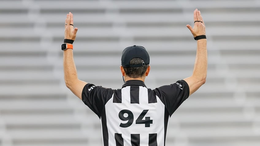 A referee signals a TD