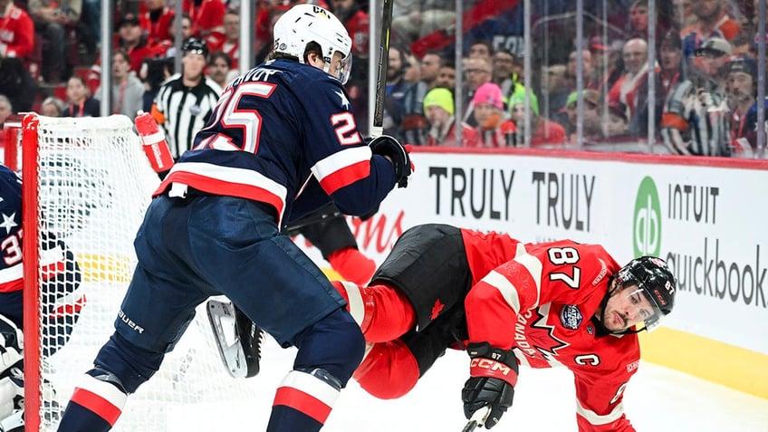 Charlie McAvoy hits Sidney Crosby