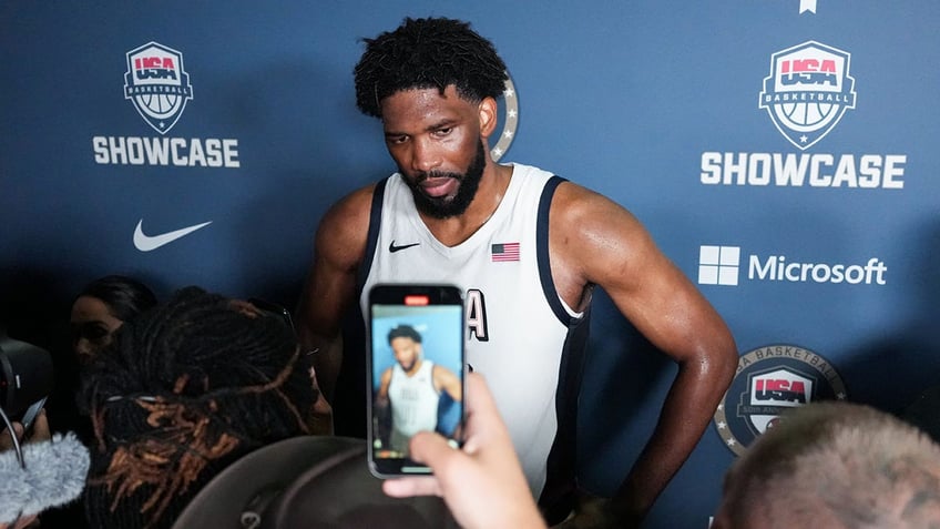 Joel Embiid talks to reporters