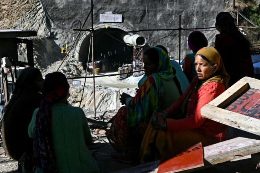 tearful families pray for indian workers trapped in tunnel